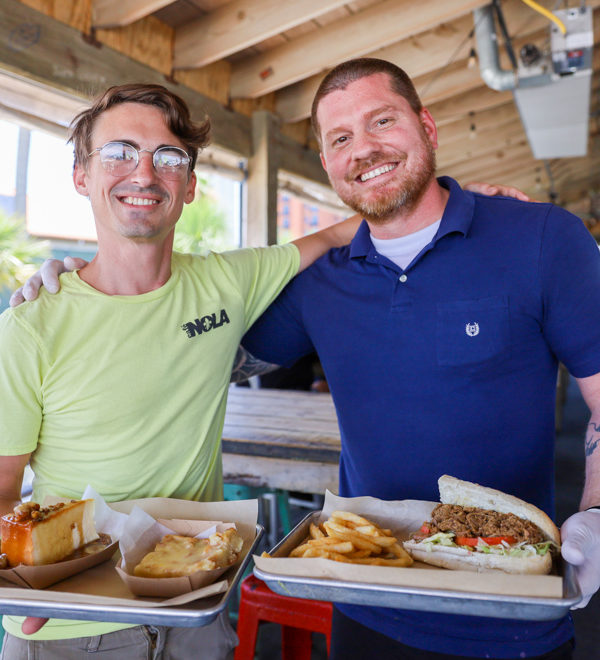 Managers of Cafe Nola on Pensacola Beach with food